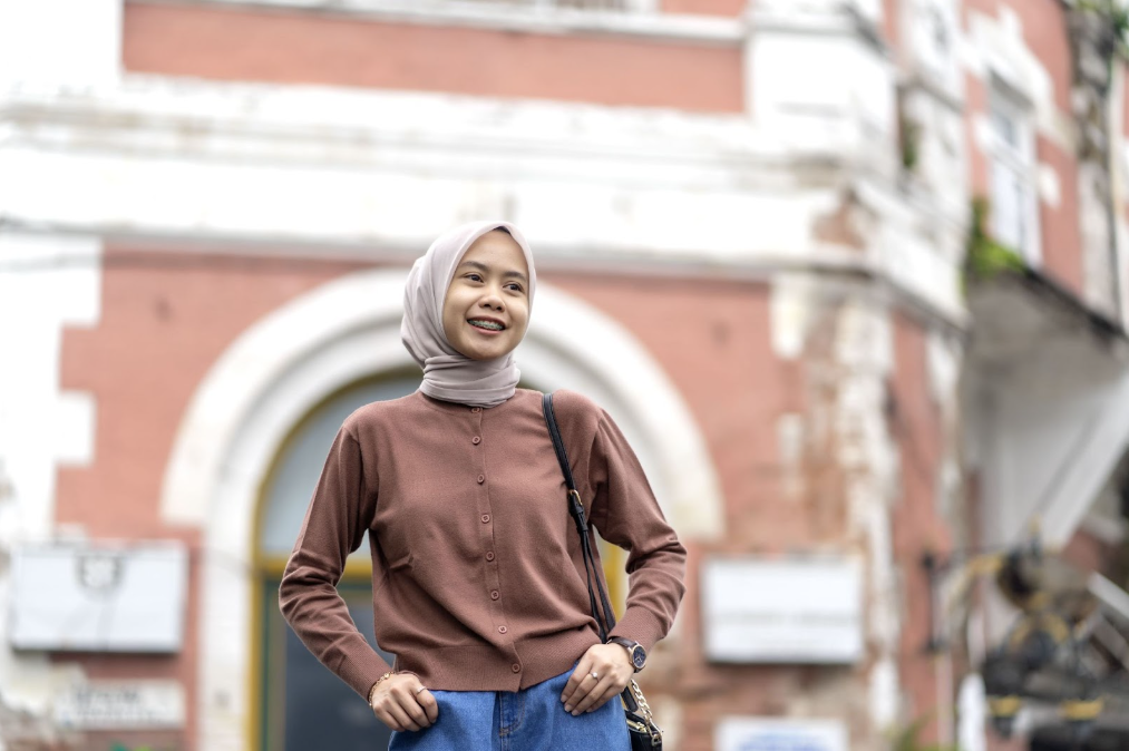 Wanita berhijab tersenyum lebar di depan kamera